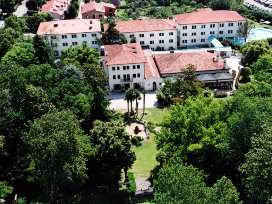 Lush landscape with a hotel and pool visible in the background.