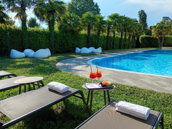 A relaxing poolside scene with chairs and refreshments.