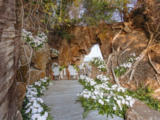 Charming flower-lined entrance to a serene beach setting