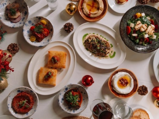 A vibrant spread of festive foods and drinks on a table.