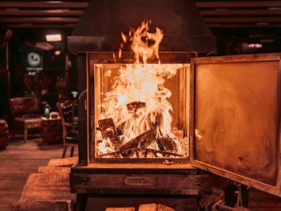 A warm fire burns in a modern fireplace setup.