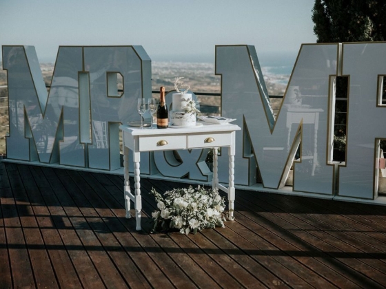 Elegant wedding display featuring cake and champagne.