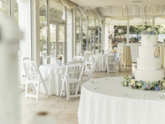 Elegant wedding venue featuring a cake and seating arrangements.