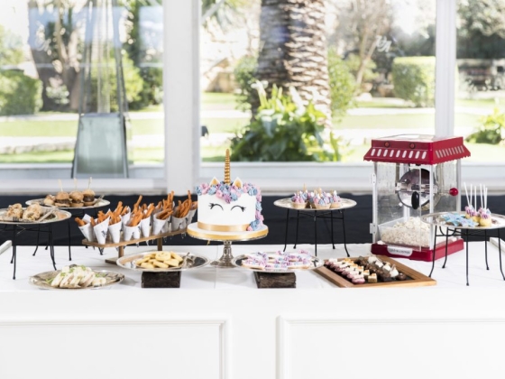 A festive setup featuring a unicorn cake and assorted treats.