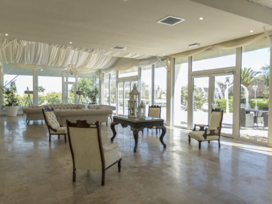 Bright, airy room with a chandelier and stylish furniture.