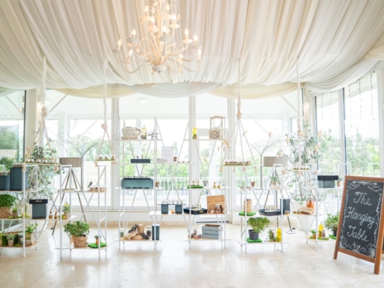 A charming hanging table setup with greenery and decor.