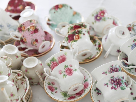 A variety of floral-patterned tea cups arranged together.