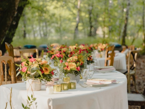 A beautifully decorated table in a forest setting.