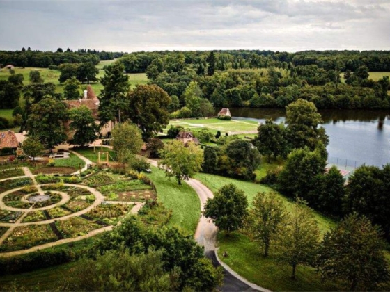 Serene landscape featuring a garden and water.