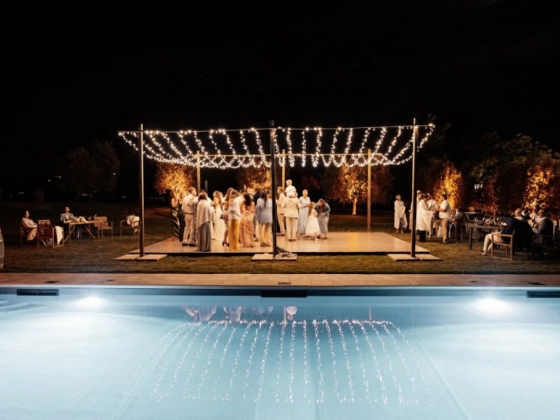 Festive gathering by the pool under twinkling lights.