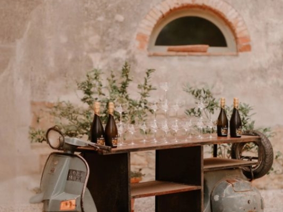Charming scooter bar set up with champagne and glasses.