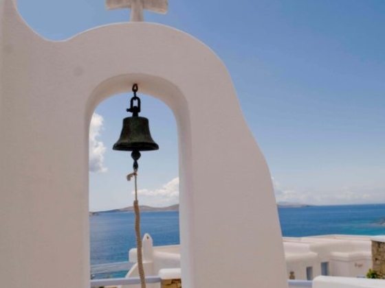 A serene bell archway overlooking the sea.