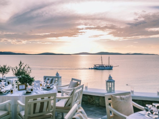 A serene sunset view over the water with a dining setup.