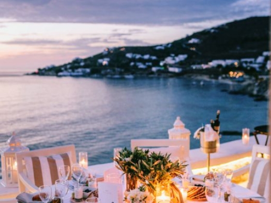 A beautifully arranged table overlooking the ocean at dusk.