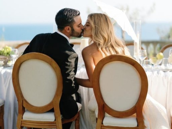 Romantic moment at an outdoor wedding setting.