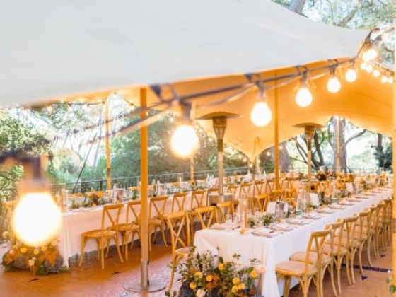 Stylish tablescape with flowers and string lights.