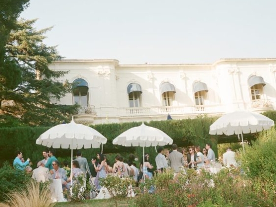 Gathering in a garden near an elegant building.