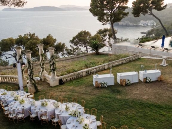 Beautifully set tables with a sea view at sunset.