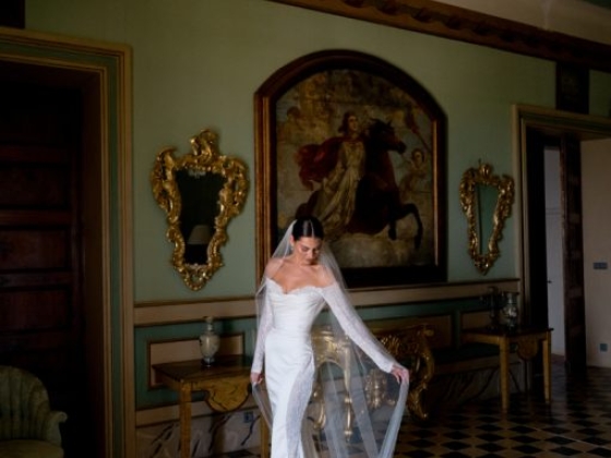 A bride poses gracefully in a luxurious, vintage setting.
