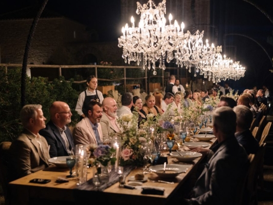 Guests enjoy a beautifully set table at night.