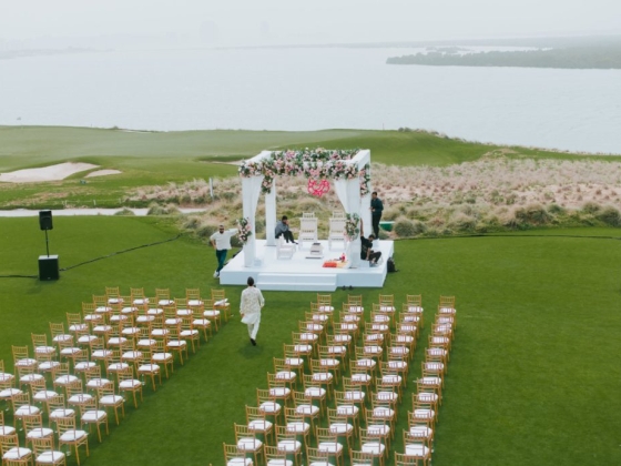 Elegant wedding venue by the water with seating arranged.