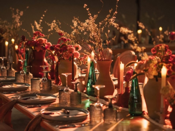 A beautifully set dinner table with floral arrangements.
