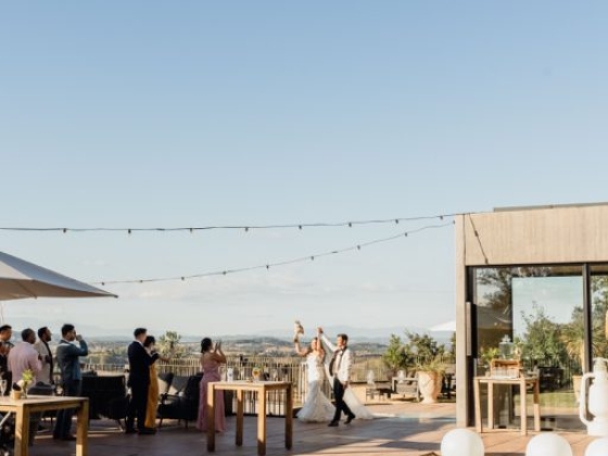 Guests enjoy a joyous wedding near a swimming pool.