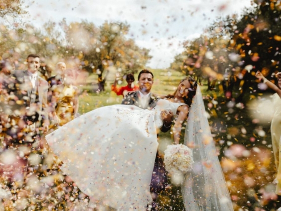 A couple celebrating their wedding surrounded by joyful friends.