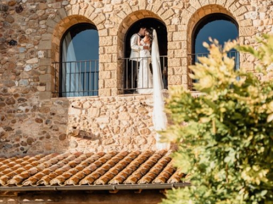 Couple sharing a moment on a balcony during their wedding