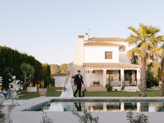 A bride and groom at a scenic villa outdoors.