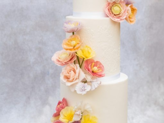 A beautiful cake adorned with vibrant flowers.