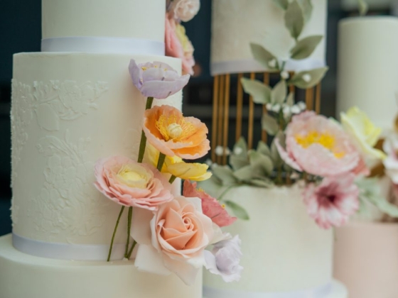 Beautifully decorated cakes with floral accents.
