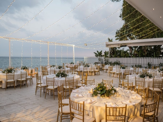 Elegant tables set for a seaside wedding reception.
