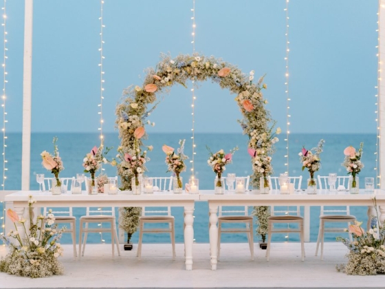 Elegant table setting against a seaside backdrop.