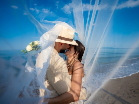 Romantic seaside wedding moment between couple.