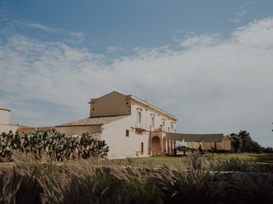 A serene view of a countryside house with a laundry line.
