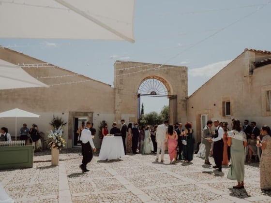 Guests celebrating at a sunny outdoor venue.