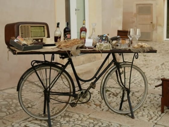 A bicycle serving as a table with eclectic vintage decor.