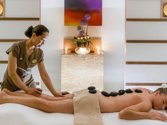 A serene spa setting with a massage in progress.