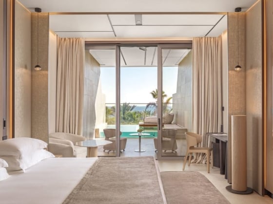 Elegant room featuring floor-to-ceiling windows and a pool view.