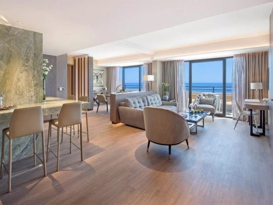 Stylish hotel suite featuring elegant decor and natural light.