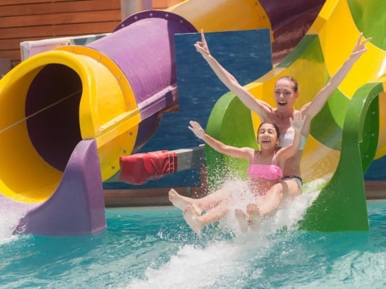 A fun moment on a water slide at a pool.