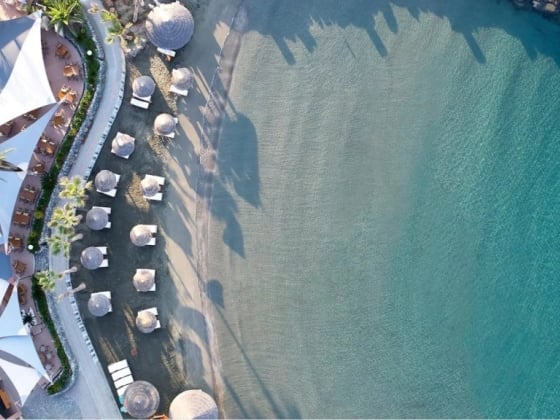 Scenic beachfront with cabanas and lounge chairs overlooking the sea