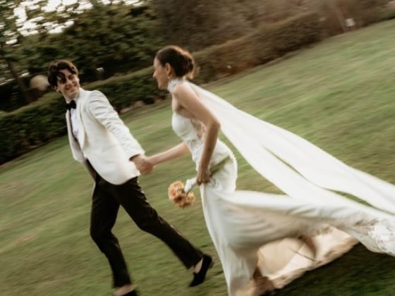 A couple enjoying their wedding day outdoors.
