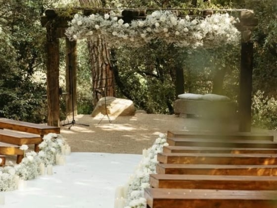 A beautiful outdoor wedding setup with wooden chairs.