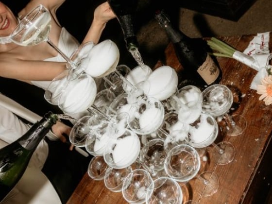 A stunning champagne tower being filled at an event.