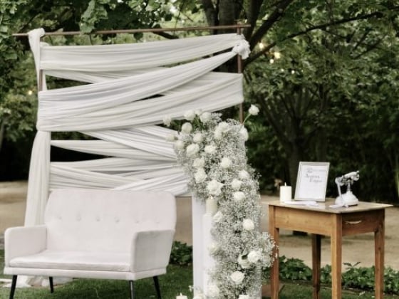 Charming decor for an outdoor event with a soft seating area.