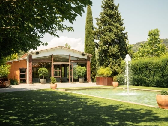 Scenic outdoor space featuring a fountain and greenery.
