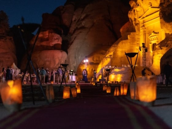 A festive gathering amidst glowing candles and illuminated rocks.