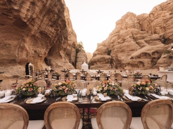 Beautiful long tables adorned with flowers in a canyon setting.